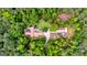 Expansive property featuring a single-story home, matching outbuilding, and a circular driveway surrounded by lush trees at 130 Brooklet Way, Brooks, GA 30205