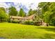 Lush backyard featuring a deck and pergola, providing a perfect space for outdoor entertaining at 130 Brooklet Way, Brooks, GA 30205