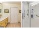 Bright bathroom featuring a glass shower with white tile, a long vanity, and tiled floors at 130 Brooklet Way, Brooks, GA 30205