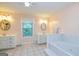 This bathroom features double sinks, large bathtub, tile floors and a large window at 130 Brooklet Way, Brooks, GA 30205
