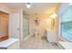Well-lit bathroom with vanity, shower, toilet, tile floors, and a bright window at 130 Brooklet Way, Brooks, GA 30205