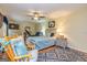 Comfortable bedroom with a ceiling fan, windows, hardwood floors, and blue accents at 130 Brooklet Way, Brooks, GA 30205