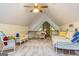 Cozy bedroom with vaulted ceiling, brick accent, ceiling fan and seating area at 130 Brooklet Way, Brooks, GA 30205