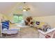 Bright bedroom with sloped ceilings, a ceiling fan, and a cozy seating area at 130 Brooklet Way, Brooks, GA 30205