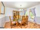 Elegant dining room featuring a glass table, decorative chairs, and natural light from a window at 130 Brooklet Way, Brooks, GA 30205