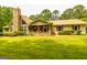 Charming home featuring a stone chimney, inviting front porch, and well-maintained landscaping at 130 Brooklet Way, Brooks, GA 30205