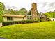 Lovely home showcasing a stone chimney, classic shutters, and a lush green lawn at 130 Brooklet Way, Brooks, GA 30205