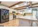 Bright kitchen with white cabinets, beams, and modern appliances at 130 Brooklet Way, Brooks, GA 30205
