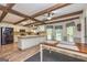 Open concept kitchen with eat-in area, white cabinets, beams and stainless steel appliances at 130 Brooklet Way, Brooks, GA 30205