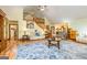Open living room boasts vaulted ceiling, fireplace, and access to the staircase for easy navigation at 130 Brooklet Way, Brooks, GA 30205
