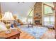 Bright living room features stone fireplace, hardwood floors, and comfortable seating for Gathering and guests at 130 Brooklet Way, Brooks, GA 30205