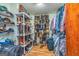 This large walk-in closet has wood floors, plastic shelving, and plenty of room for clothes at 130 Brooklet Way, Brooks, GA 30205