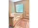 Relaxing bathroom with a soaking tub, tile accents, and a large window for natural light and ventilation at 305 Glenloch Ln, Stockbridge, GA 30281