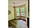 Bright dining area with natural light from windows, complete with a chandelier and laminate flooring at 305 Glenloch Ln, Stockbridge, GA 30281