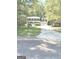 Two-story house with front porch and two-car garage surrounded by trees and landscaping at 305 Glenloch Ln, Stockbridge, GA 30281