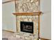 Close-up of fireplace with stone surround and hearth at 305 Glenloch Ln, Stockbridge, GA 30281