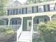 Charming two-story home with a welcoming front porch and well-maintained landscaping at 305 Glenloch Ln, Stockbridge, GA 30281