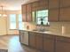 Charming kitchen featuring bright windows, wood cabinets and stainless steel appliances at 305 Glenloch Ln, Stockbridge, GA 30281
