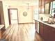 Open kitchen with modern stainless steel appliances and hardwood floors, flowing into dining area at 305 Glenloch Ln, Stockbridge, GA 30281