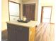 Kitchen island with storage features a light countertop and hardwood floors at 305 Glenloch Ln, Stockbridge, GA 30281