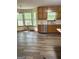 Bright kitchen features stainless steel appliances, wood cabinets, hardwood floors and bay window at 305 Glenloch Ln, Stockbridge, GA 30281
