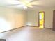 Spacious living room with neutral carpet and a ceiling fan offering a bright and airy atmosphere at 305 Glenloch Ln, Stockbridge, GA 30281