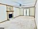 Large carpeted living room offers stone fireplace and French doors at 305 Glenloch Ln, Stockbridge, GA 30281