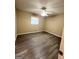 Cozy bedroom featuring modern ceiling fan and sleek gray wood floors, creating a relaxing space at 229 Timberland Trl, Riverdale, GA 30274