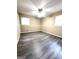 Bright bedroom showcasing a ceiling fan and elegant gray wood floors, offering a comfortable retreat at 229 Timberland Trl, Riverdale, GA 30274
