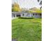 Charming single-story home with a lush front yard, carport, and grey brick at 229 Timberland Trl, Riverdale, GA 30274