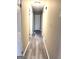 Hallway featuring laminate flooring, neutral walls, and doors leading to various rooms at 229 Timberland Trl, Riverdale, GA 30274