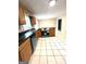 Open kitchen with updated appliances, oak cabinets, tile flooring, and lots of counterspace at 229 Timberland Trl, Riverdale, GA 30274