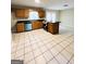 Large kitchen with tile floors, oak cabinets, and an island at 229 Timberland Trl, Riverdale, GA 30274