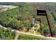 Expansive aerial view of the property's acreage, showcasing the home's setting amidst lush greenery at 3499 S Ola Rd, Locust Grove, GA 30248