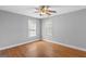 Spacious bedroom features gleaming hardwood floors and a ceiling fan at 3499 S Ola Rd, Locust Grove, GA 30248