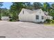 Side view of home featuring a three-car garage and large driveway at 3499 S Ola Rd, Locust Grove, GA 30248