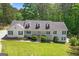 Charming home featuring a gabled roof, white siding, and a welcoming front porch and manicured front lawn at 3499 S Ola Rd, Locust Grove, GA 30248
