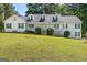 Charming two-story home featuring a covered porch and a well-manicured front yard and mature trees at 3499 S Ola Rd, Locust Grove, GA 30248