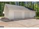 Detached three-car garage offering ample parking and storage space with a concrete driveway at 3499 S Ola Rd, Locust Grove, GA 30248
