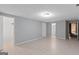 Spacious living room with neutral paint, tile floors, and multiple entryways providing seamless flow at 3499 S Ola Rd, Locust Grove, GA 30248