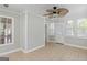 Enclosed porch featuring ceiling fan and large sliding glass door with access to outdoor porch at 3499 S Ola Rd, Locust Grove, GA 30248