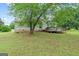 Lush backyard features a spacious lawn and a charming wooden deck at 1704 New Hope Rd, Locust Grove, GA 30248