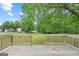 Large backyard featuring a wooden deck and lush green trees at 1704 New Hope Rd, Locust Grove, GA 30248