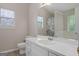Bright bathroom featuring a white vanity, a large mirror, and a shower with a patterned curtain at 1704 New Hope Rd, Locust Grove, GA 30248