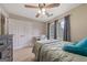 Charming bedroom with a ceiling fan, large window, closet, and soft carpet at 1704 New Hope Rd, Locust Grove, GA 30248