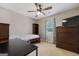 Bedroom featuring a bed, desk, and dresser with a window letting in natural light at 1704 New Hope Rd, Locust Grove, GA 30248