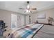 Spacious bedroom with a bed with a patterned coverlet, and access to an ensuite bathroom at 1704 New Hope Rd, Locust Grove, GA 30248