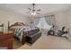 Bright bedroom with a tray ceiling, fan, patterned comforter, and a large window for natural light at 1704 New Hope Rd, Locust Grove, GA 30248