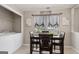 Cozy breakfast nook area featuring a dining table, laundry closet, and window with decorative sheer curtains at 1704 New Hope Rd, Locust Grove, GA 30248