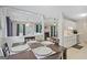 View of a dining room with a wooden table and the kitchen with stainless steel appliances in the background at 1704 New Hope Rd, Locust Grove, GA 30248